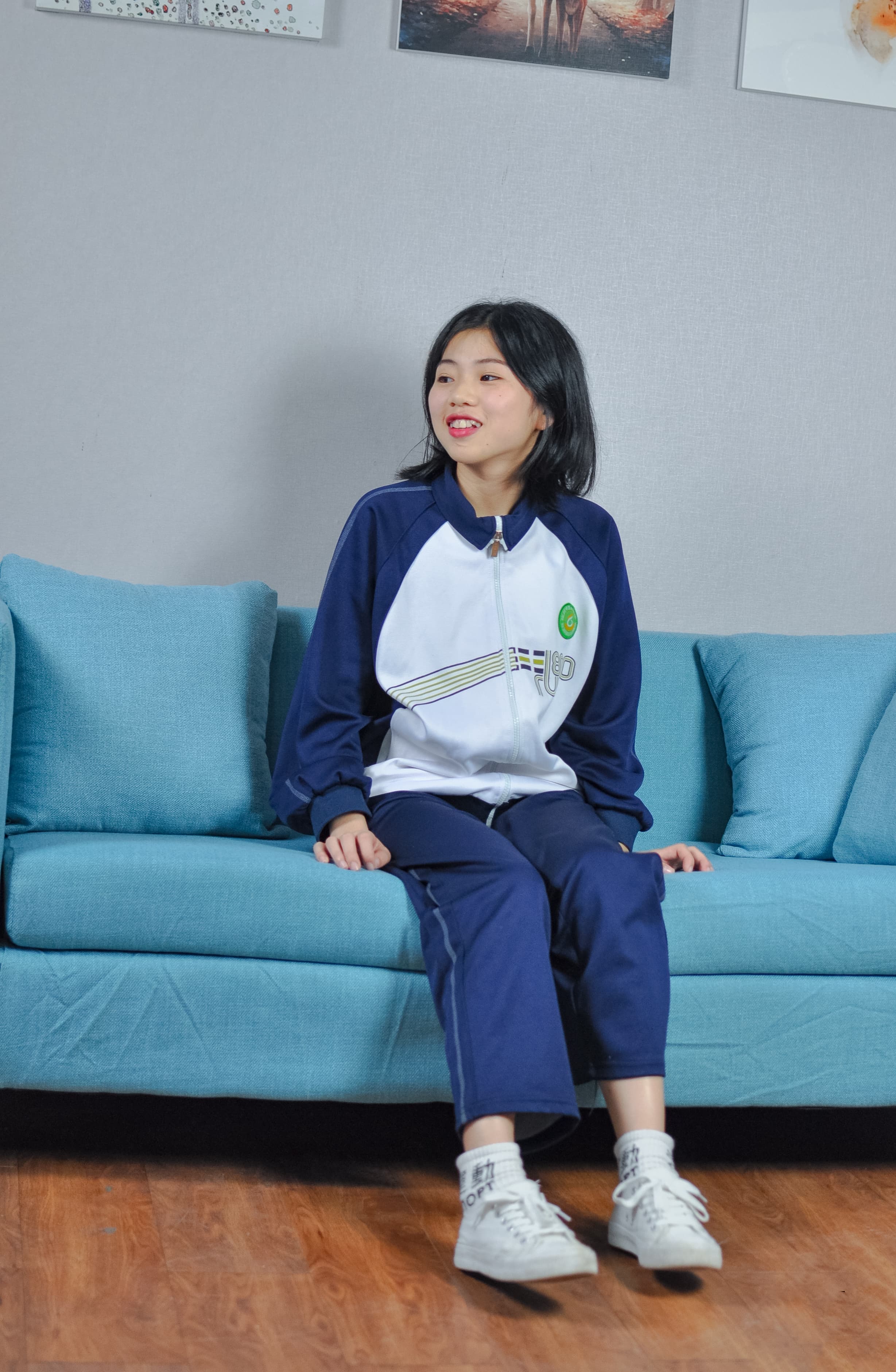 Three-quarter view of young woman lounging, soles exposed, delicate stocking sheen and relaxed toes visible