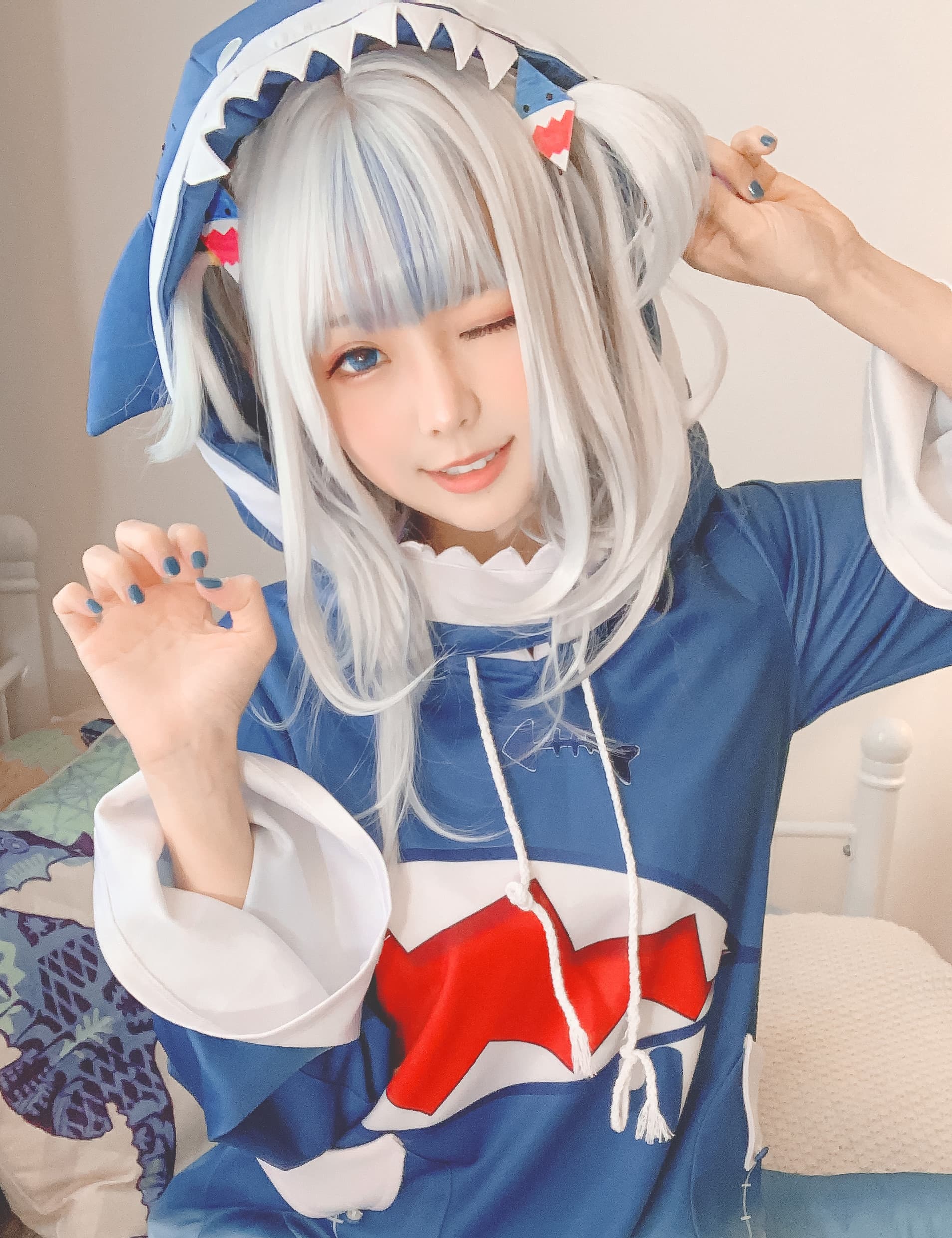 Gawr Gura cosplay with playful stockings, bare toes peeking from frilled socks on a soft floor