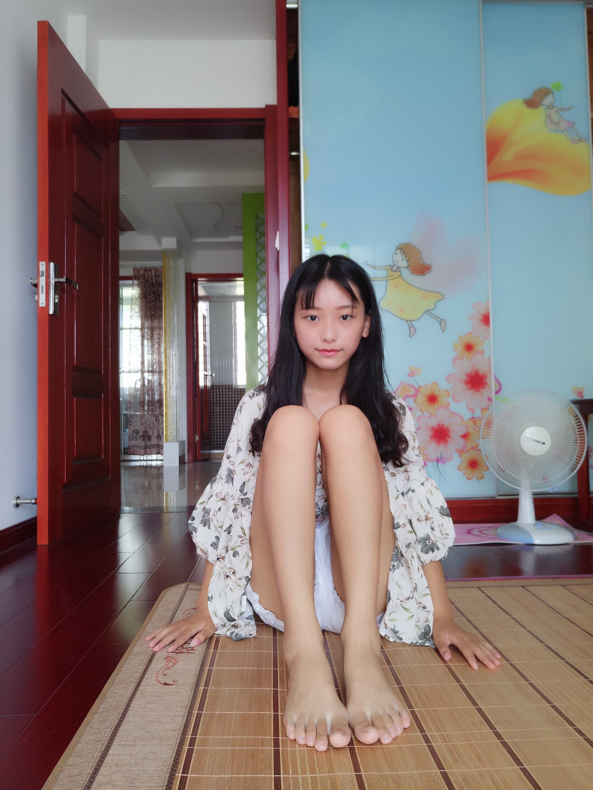 Floral skirt swaying to reveal bare feet and delicate ankle socks, toes slightly curled