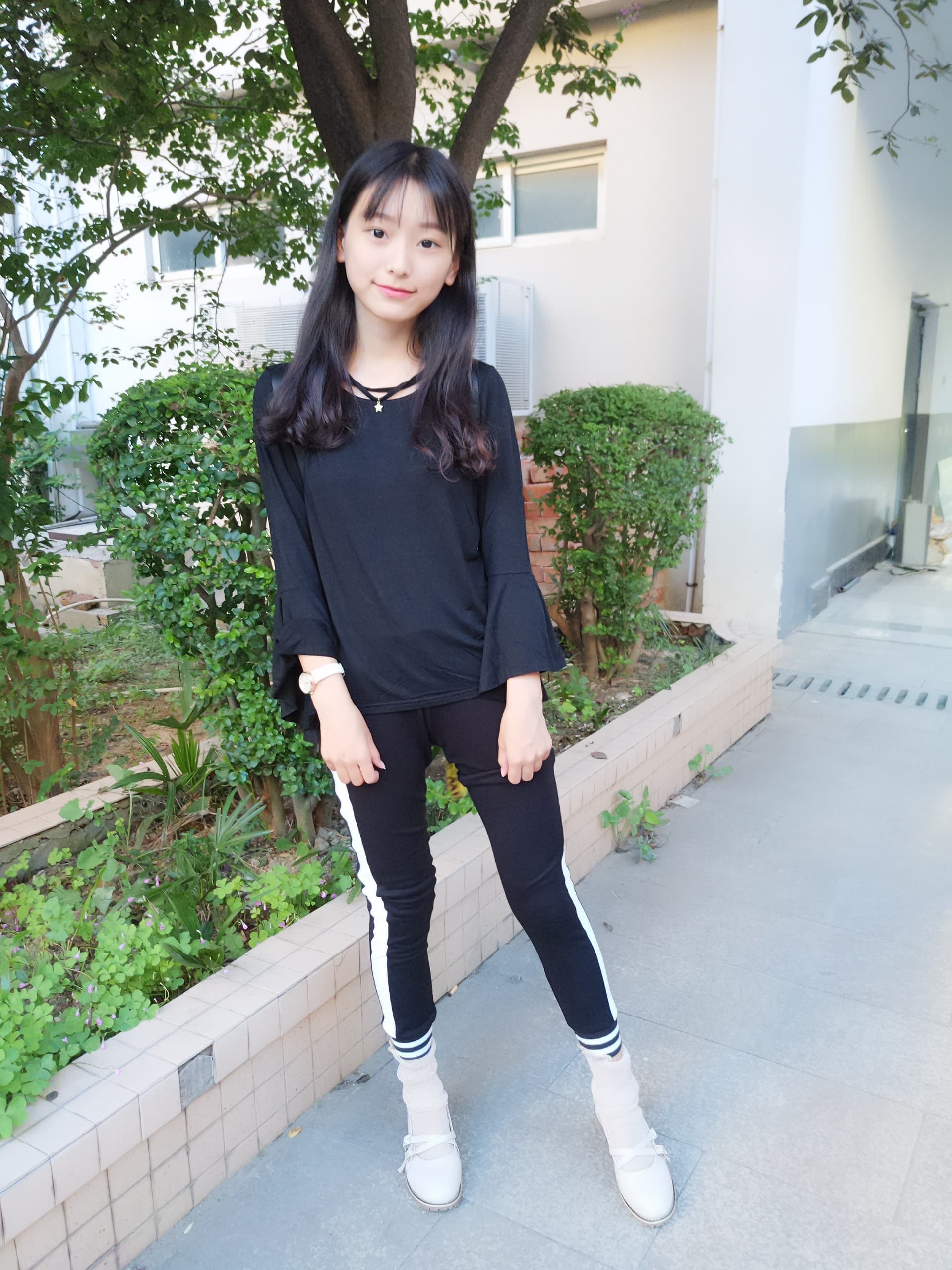 Close shot of nylon-covered legs and bare feet beneath a short skirt, soft focus, playful pose