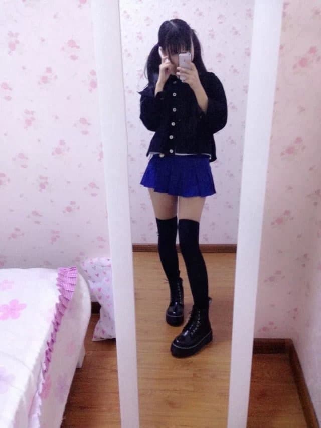 Close-up of toes peeking from thin socks beside glossy nylon-clad calf on cozy bedspread