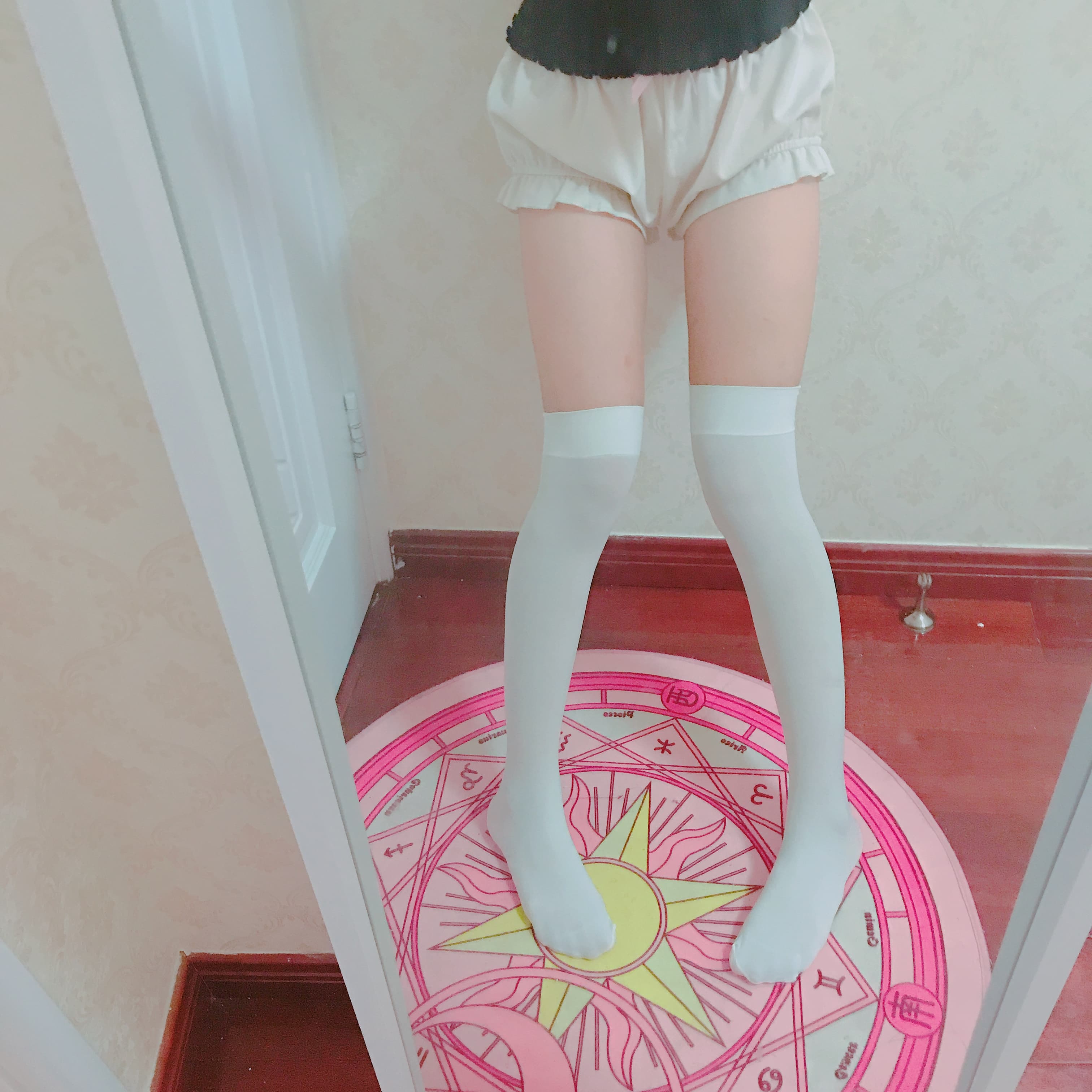 Long white overknee socks hugging thighs and calves, feet bare with toes just visible beneath the cuffs