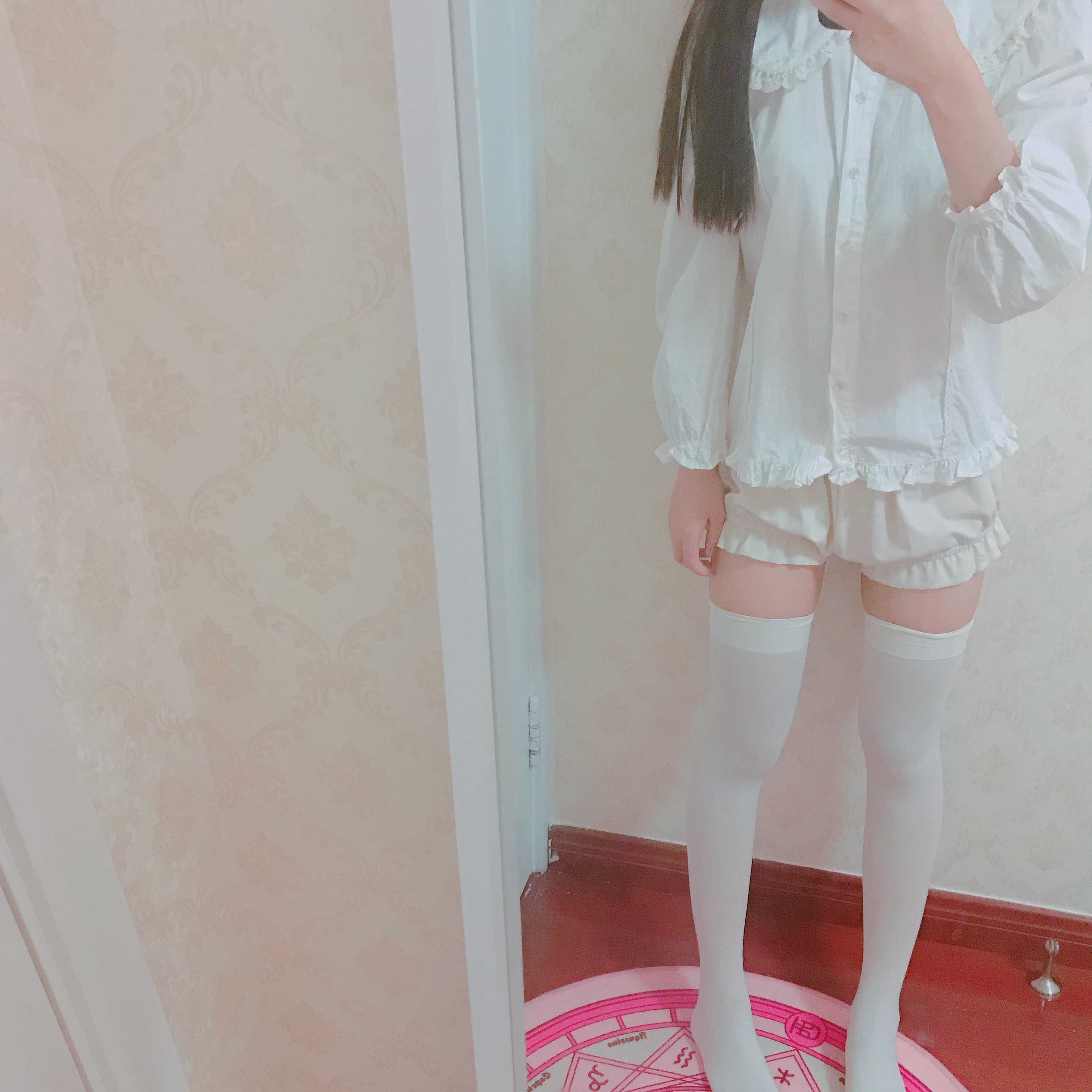 Playful pose of legs in knee-high white socks, one heel raised to show sole and sock texture