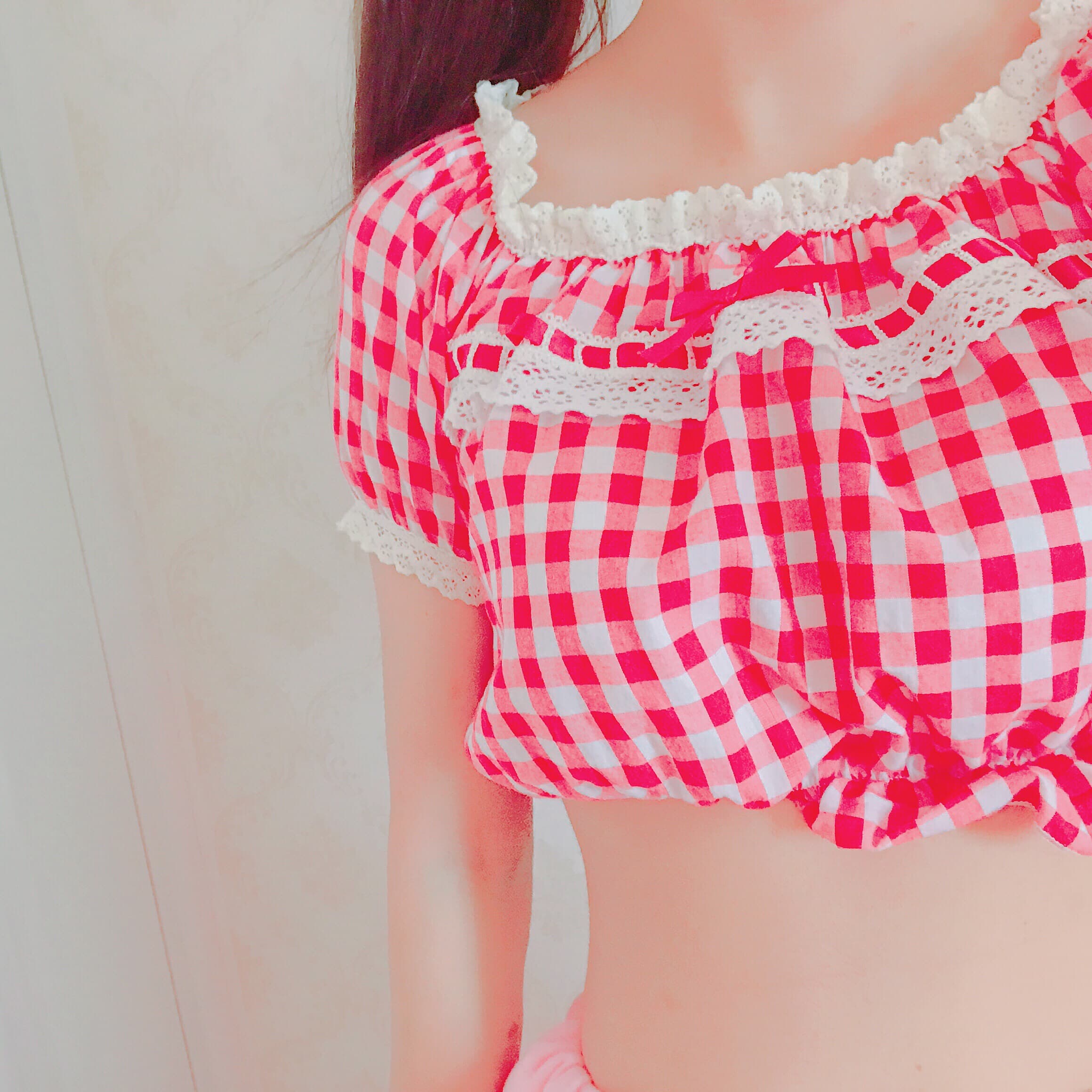 Legs in glossy white pantyhose peeking from pink shorts, sheer nylon hugging the calves and thighs