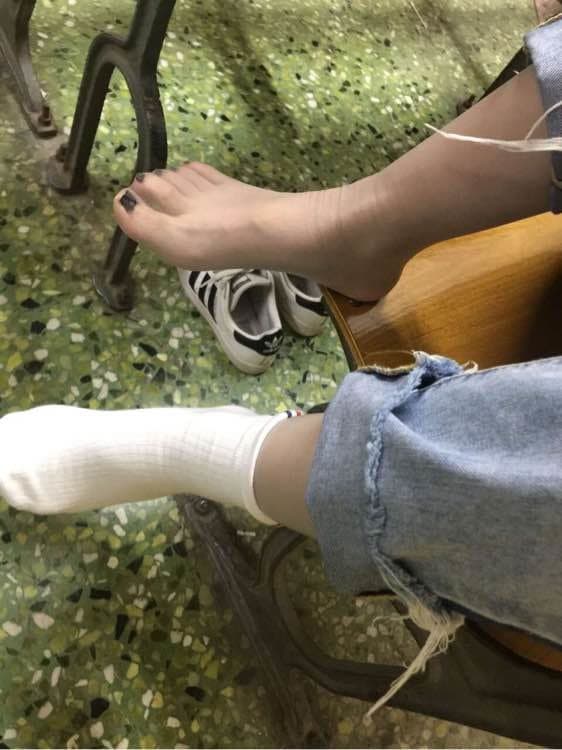 Beautiful girl just finished a run, took off her white cotton socks to reveal her sheer stockings