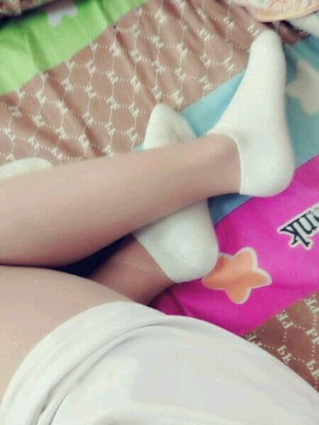 Beautiful woman's cotton socks feet leaked at home
