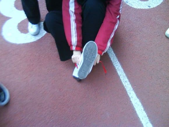 Quick candid shot of a bare foot stepping forward, toes splayed and heel lifted against hardwood.