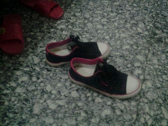 Close-up of girlfriend's cotton-socked feet dangling, slight wear, soft creases hinting at scent and intimacy.