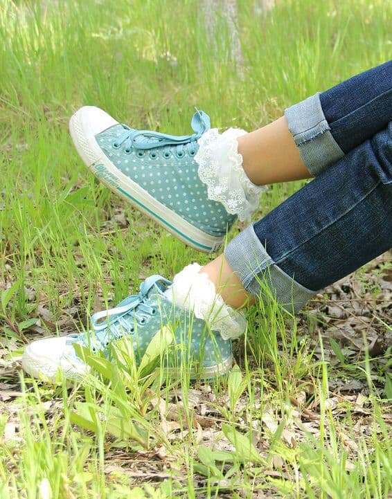 Collection of adult partner's well-worn cotton socks on feet, showing textured knit and snug contours