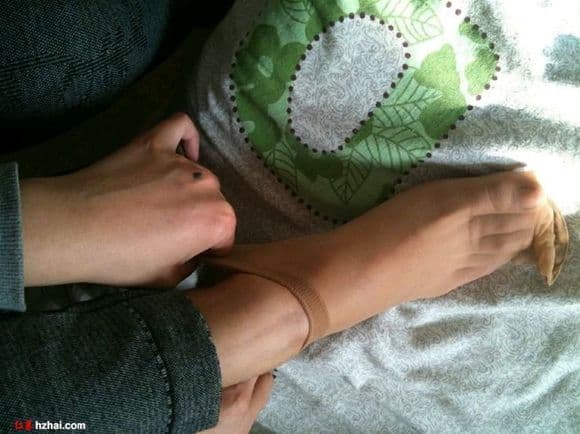 Small, delicate barefoot posed gently on a soft surface, toes slightly curled and relaxed