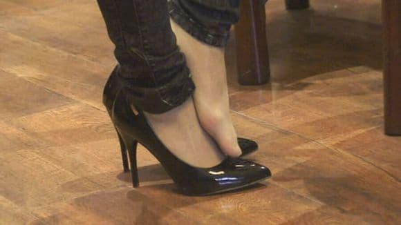 Newcomer barefoot reveal with soft cotton socks pushed down, showing a warm, natural sole