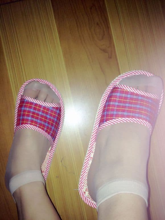 Artful close-up of a sculpted arch with soft sole and subtle stocking sheen