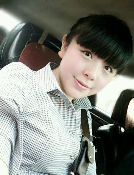 Elegant shot of an arched foot in glossy nylon stocking against dark backdrop