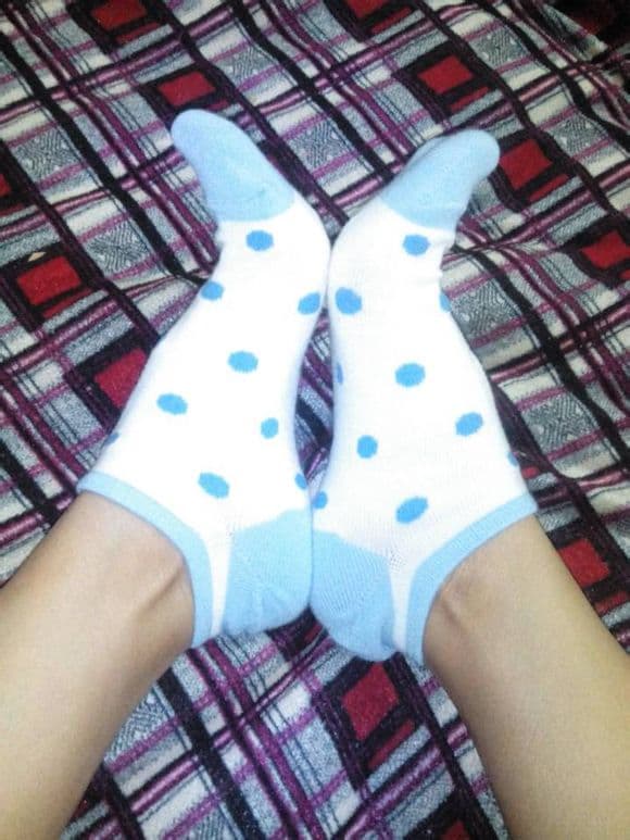 Arrangement of several sock pairs with boat socks highlighted, ankle exposure and toe detail in soft light