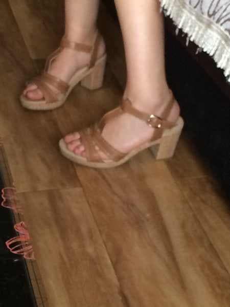 Feet in boat socks slipping into leather shoes, sock cuff visible and fabric creases emphasized