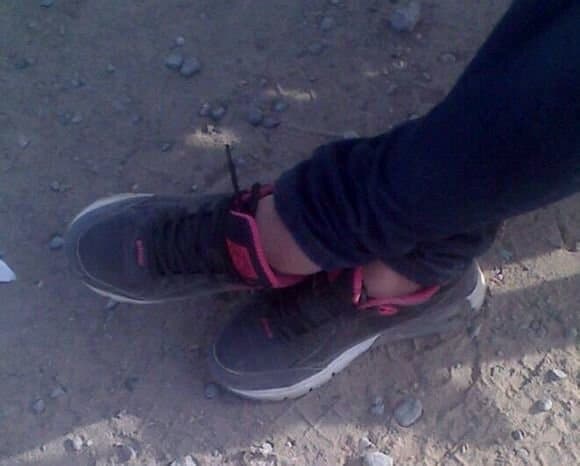 Close-up of short sheer stockings hugging an arch with bare toes peeking, nylon shimmer catching soft light