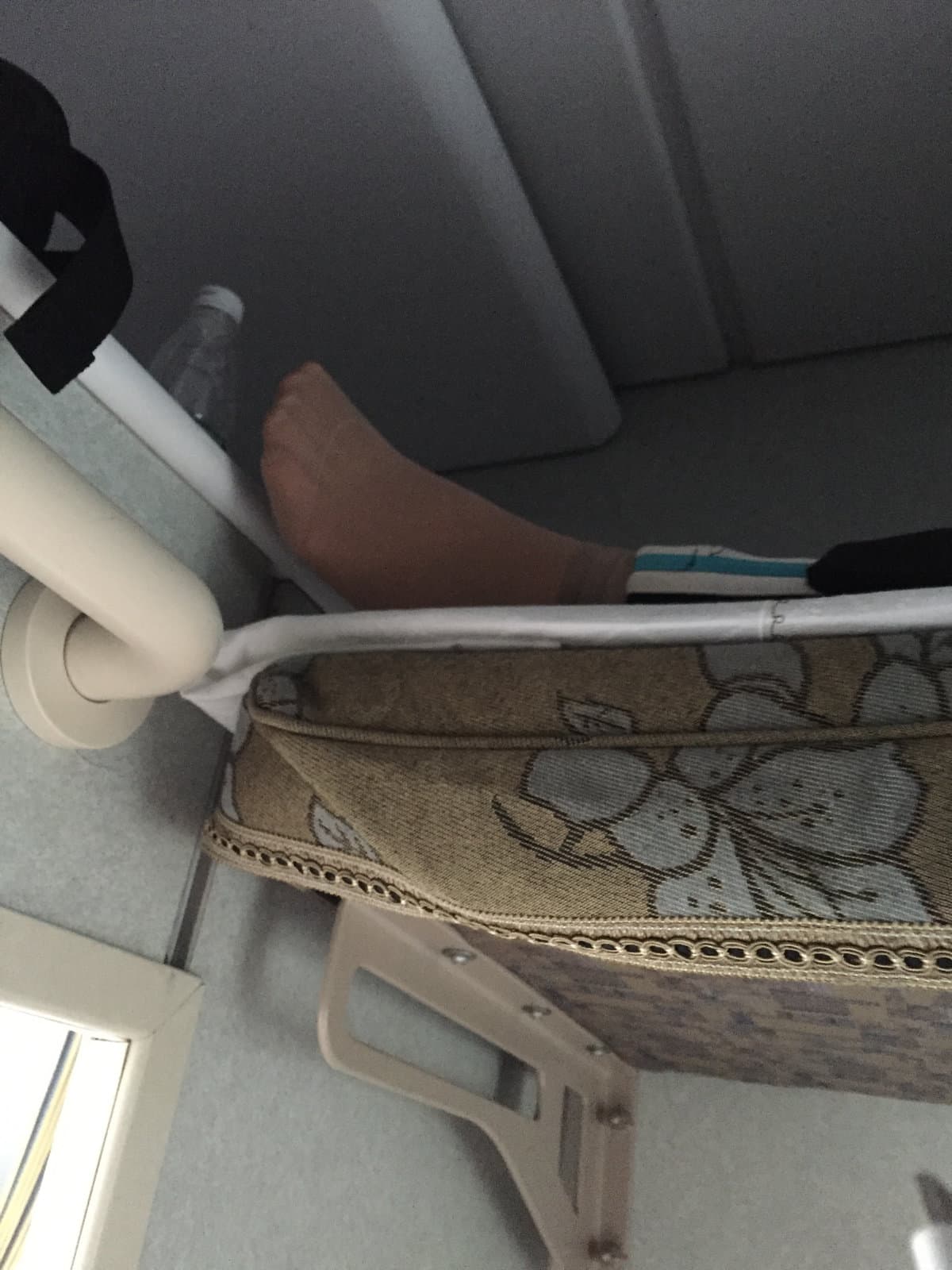 Natural pose of feet in slightly wrinkled sheer stockings revealing bare heel curve