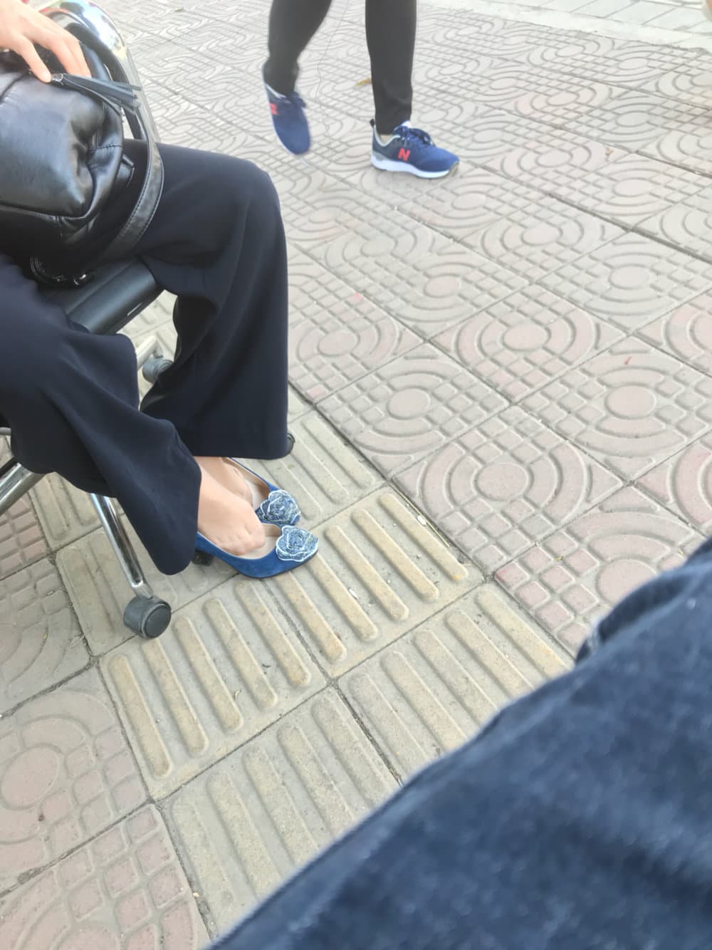 Close-up of arched bare foot slipping out of sheer black stocking over toes