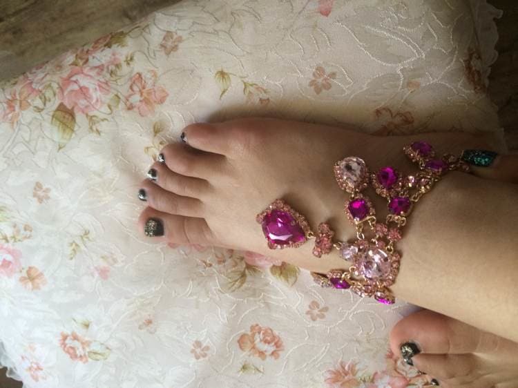 Intimate close-up of a single pretty foot resting, toes relaxed and arch softly curved with smooth skin detail