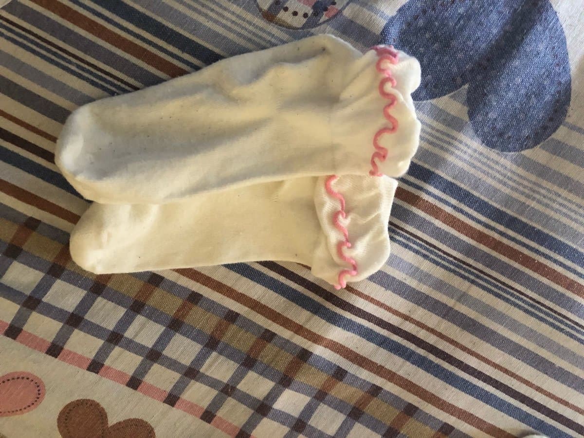 worn cotton socks on floor