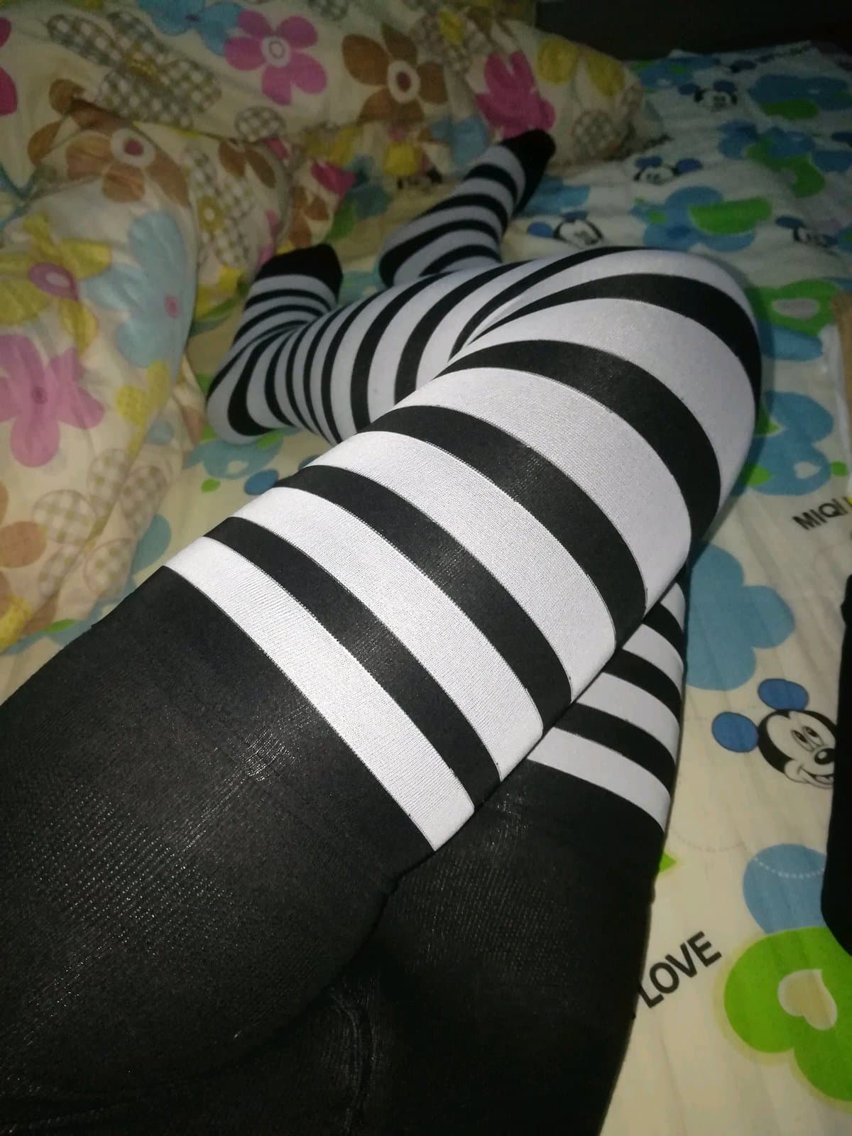 Casual candid of bare toes peeking from frayed nylons while lounging on a sunlit couch