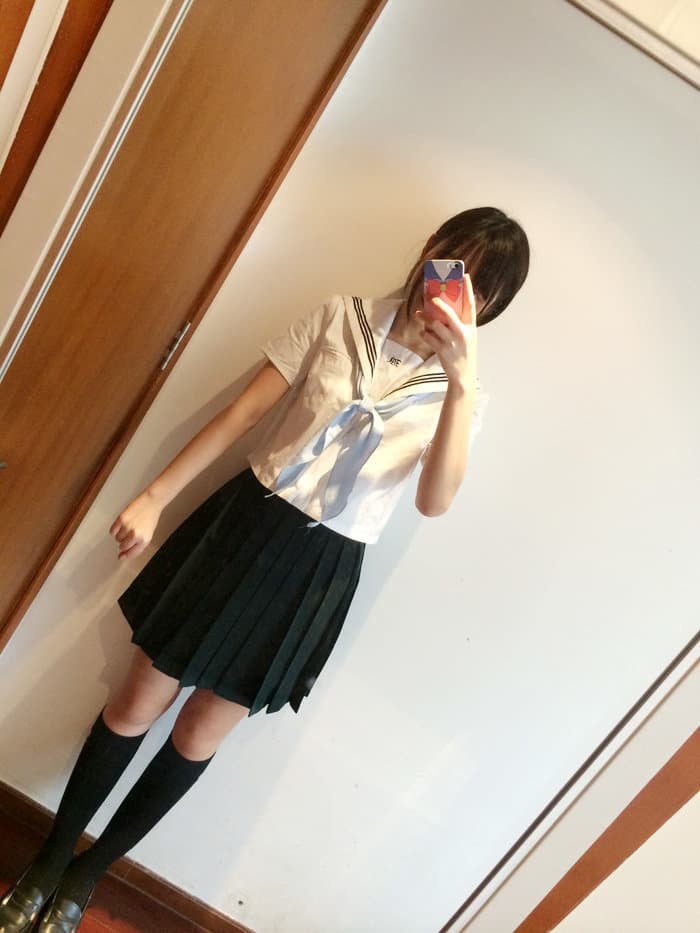 Moody shot of feet in dark green stockings curled on crimson velvet, textures emphasized