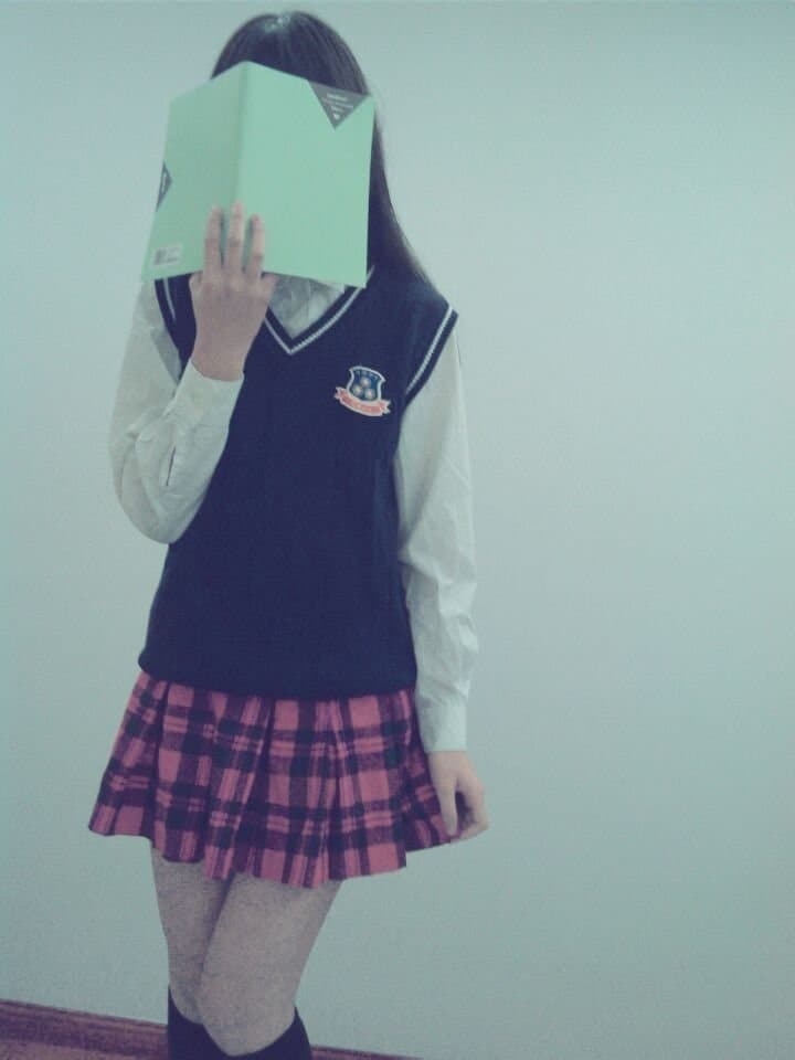 Campus-inspired scene with young woman’s bare feet crossed on bench, ankle socks pushed down