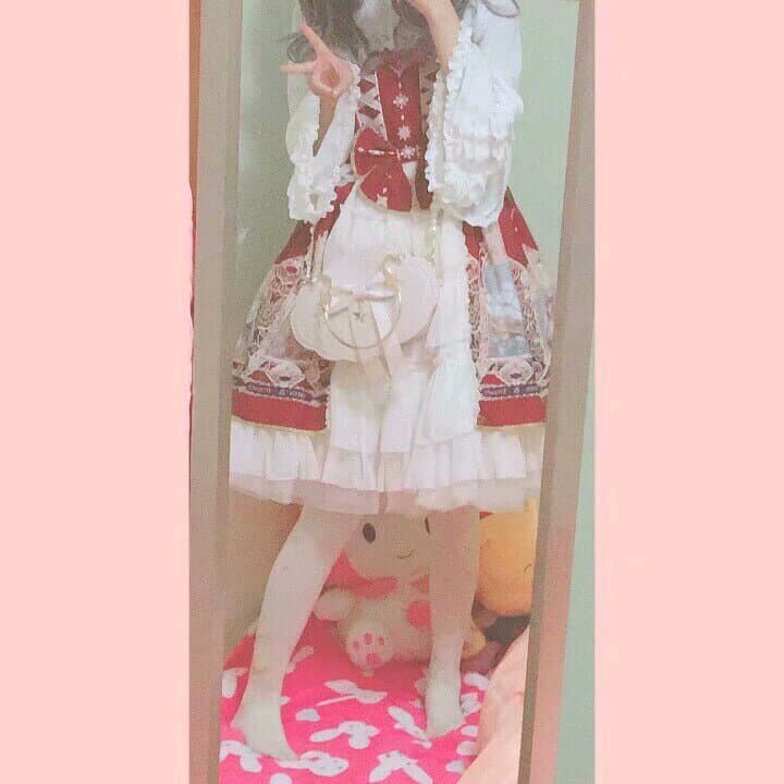 Instructional-style photo of adult model demonstrating a thigh-high stocking being rolled down, toes pointed to accentuate the arch under soft light.