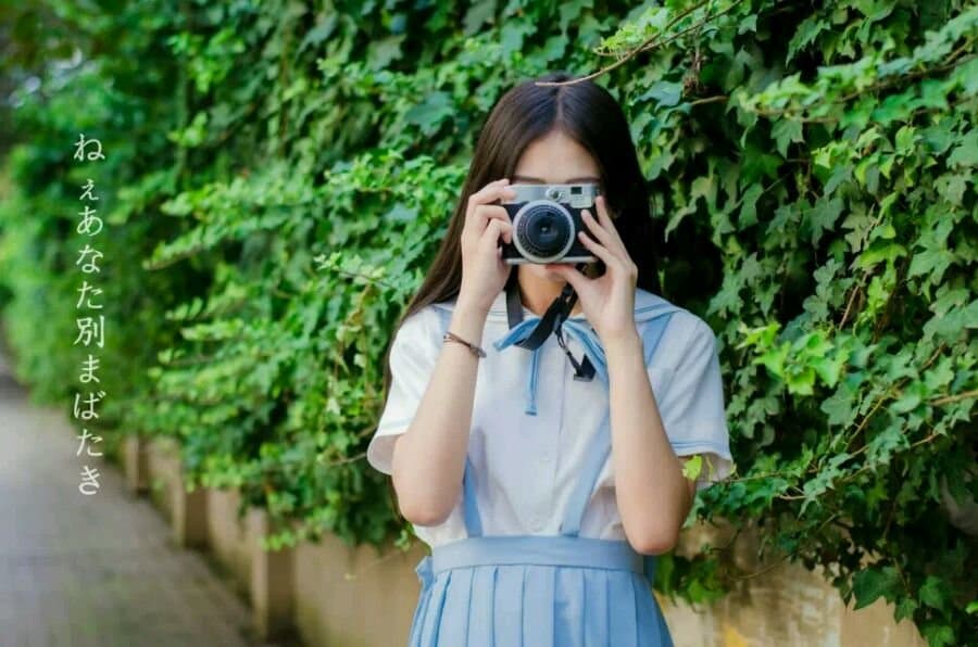 Adult woman walking barefoot on sunlit pavement, stockings rolled to her knees and toes splayed to feel the summer warmth against her soles.
