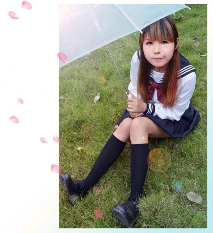 Fujoshi at home with stockings rolled to ankles, socks loosely worn, toes resting on a stack of manga books