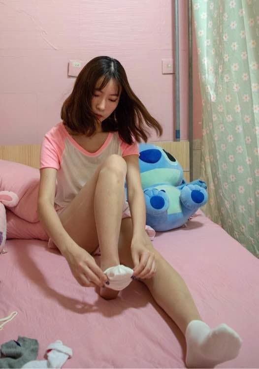 Cozy living room shot with bare feet tucked under a blanket, soft carpet and warm light framing the scene