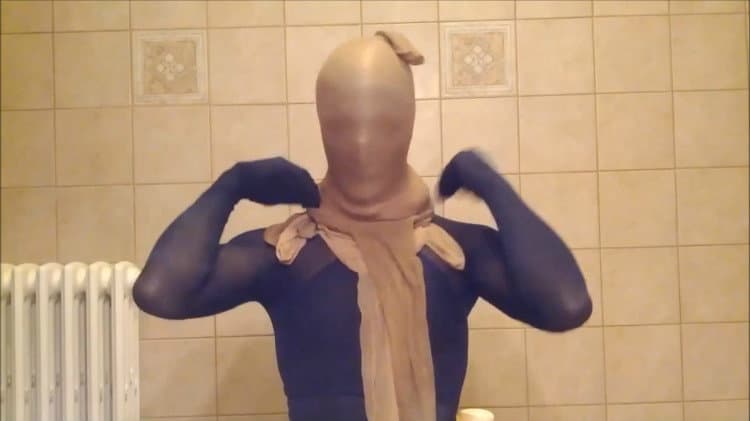 Adult model in a hooded top sits cross-legged, layered socks and sheer stockings visible as she slides one sock down to expose the foot.