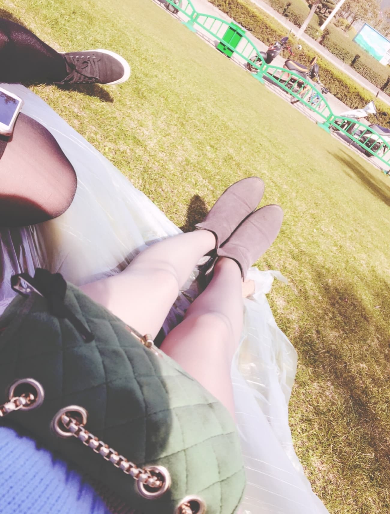 Sunlit legs with stockings rolled down at the ankle, toes flexing against warm wooden boards.