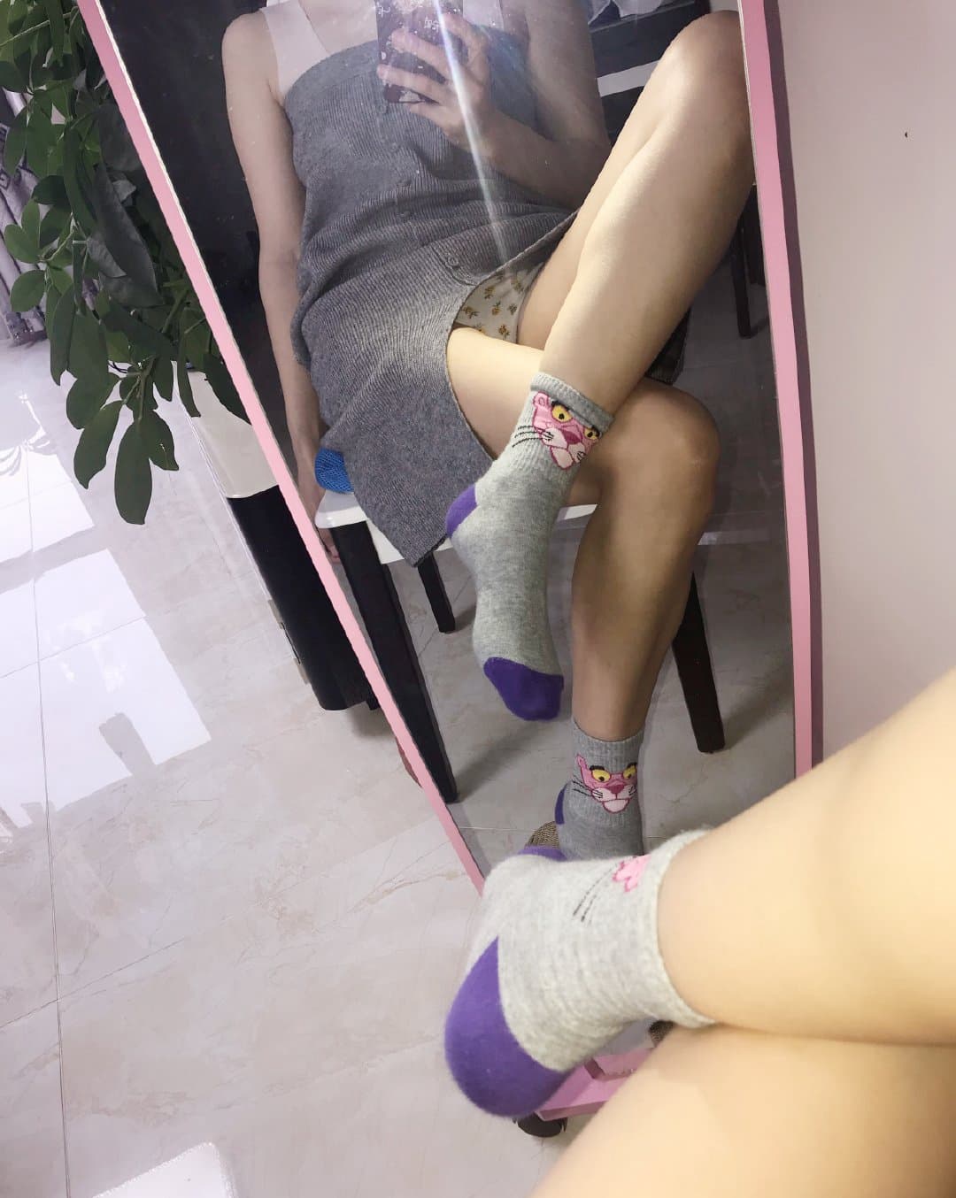 Elegant feet in sheer stockings peeking from under a skirt hem, toes defined and nylon smoothing the foot profile under soft light.