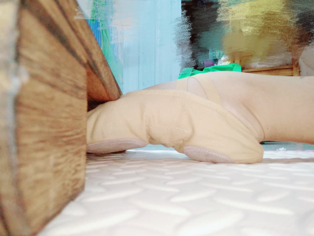 Close-up of a high instep with soft lighting, showing fine skin details and the graceful curve from heel to toe