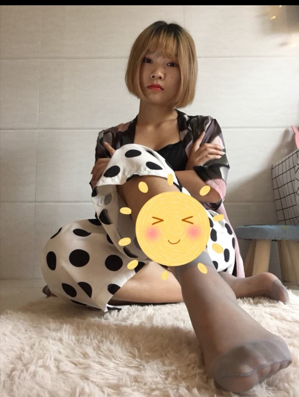 Morning close-up of bare feet stretching from under a blanket, cotton socks pushed down at the ankles.