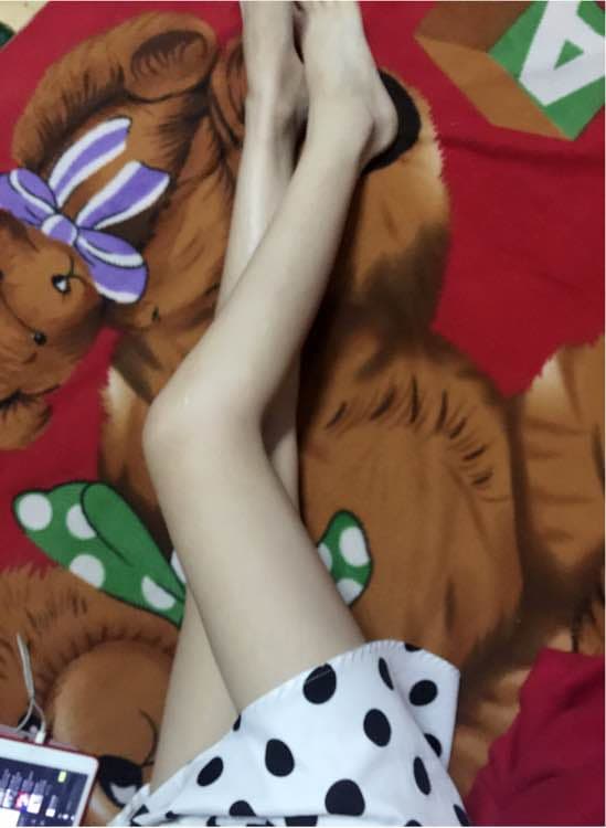 Soft portrait of a foot in a slightly worn cotton sock, stocking nearby, evoking comfort and long-standing affection