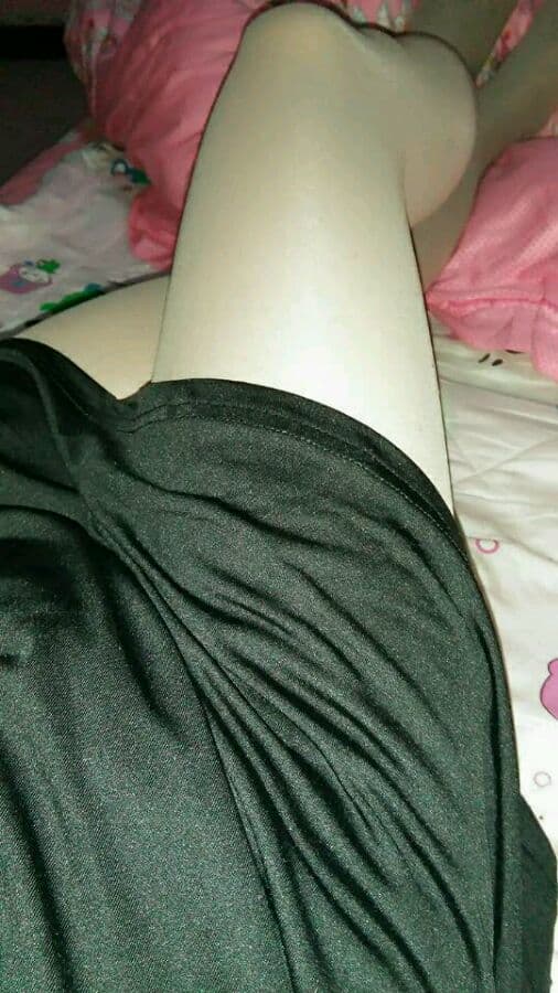 Casual late-night shot of feet propped on a couch wearing mismatched cotton socks and stockings, mood lighting soft and suggestive