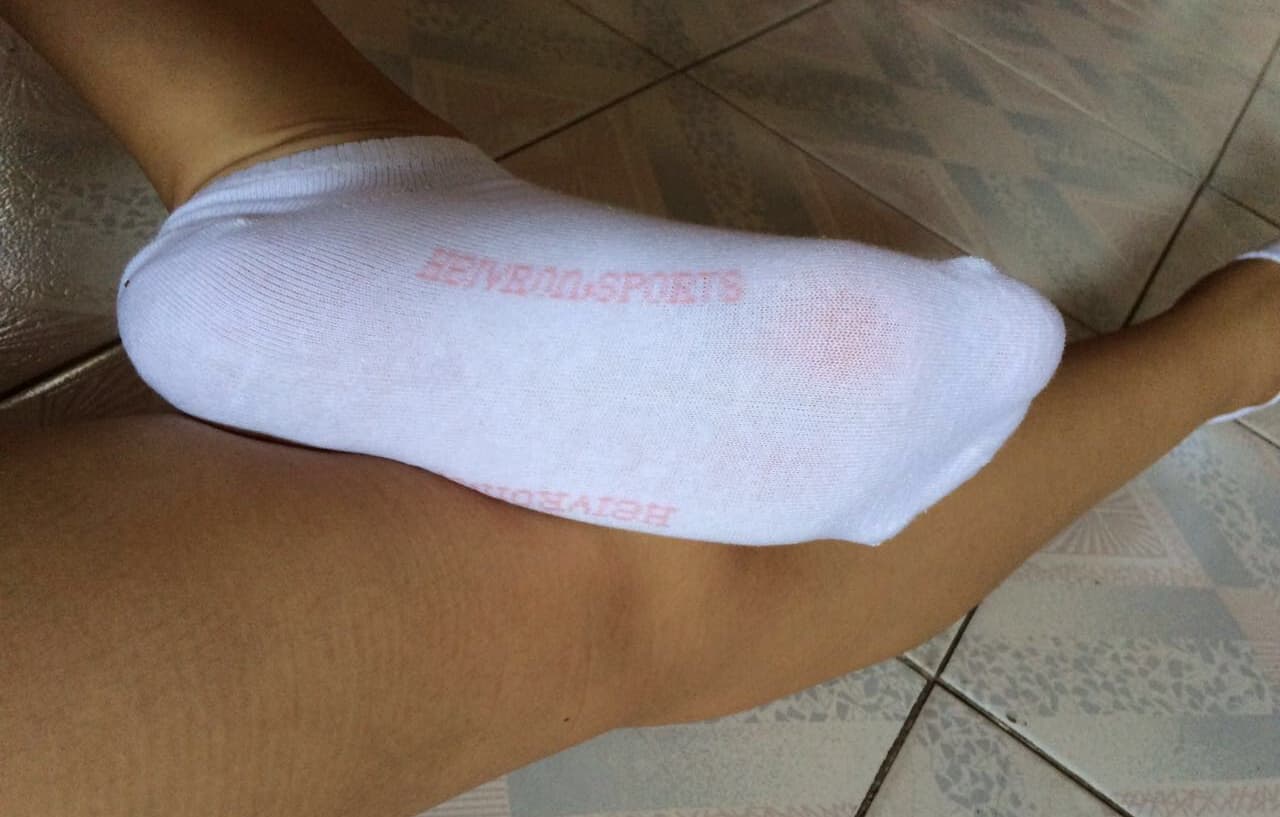 Toes peeking from ribbed cotton socks