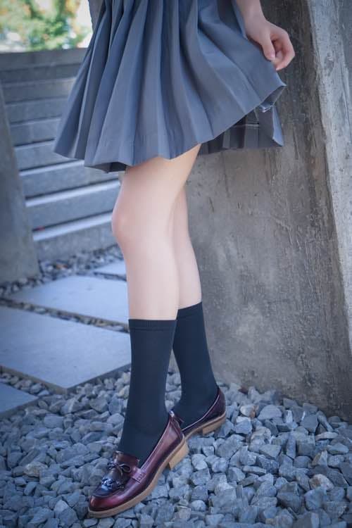 Two pairs of feet intertwined gently