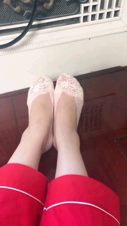 Feet presented with one bare and one in sheer stocking, toes relaxed and inviting