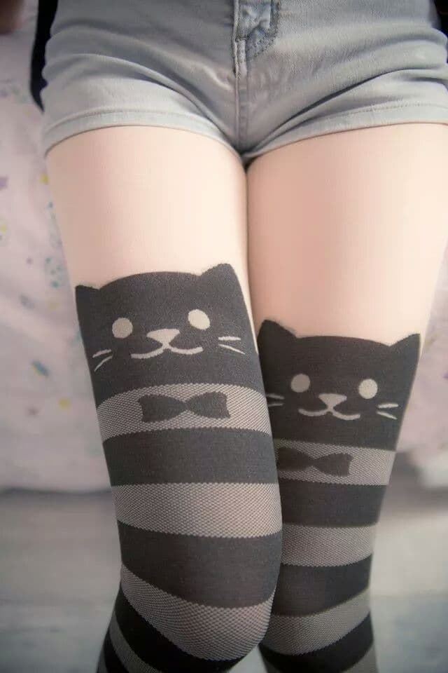 Close-up of flower print socks on bare feet, toes peeking and soft arch visible in warm light