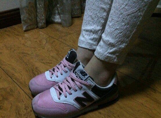 Ankle peeking from low sneakers