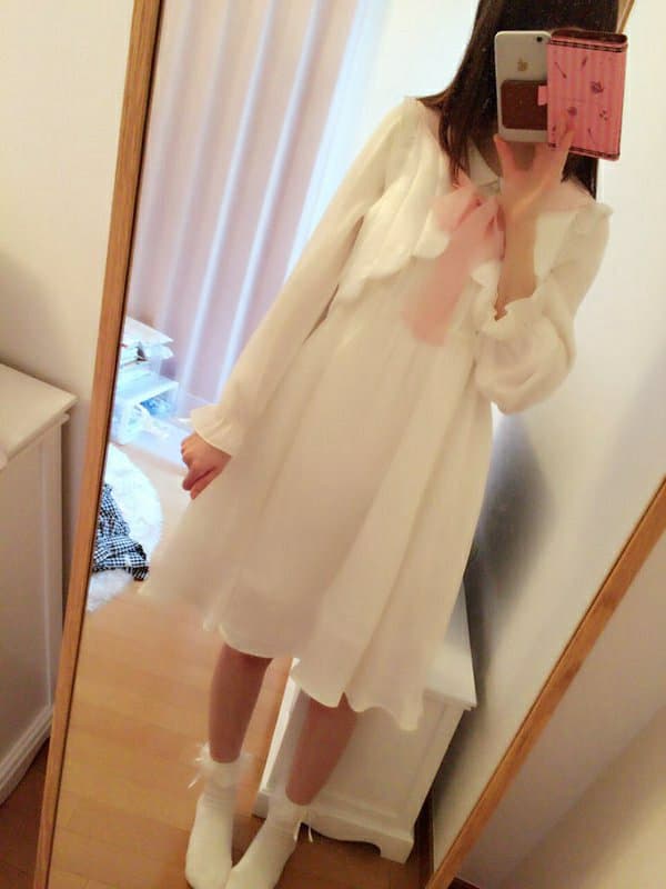 Woman at home with tea, heels off, nylons rolled down revealing tender arches and relaxed toes