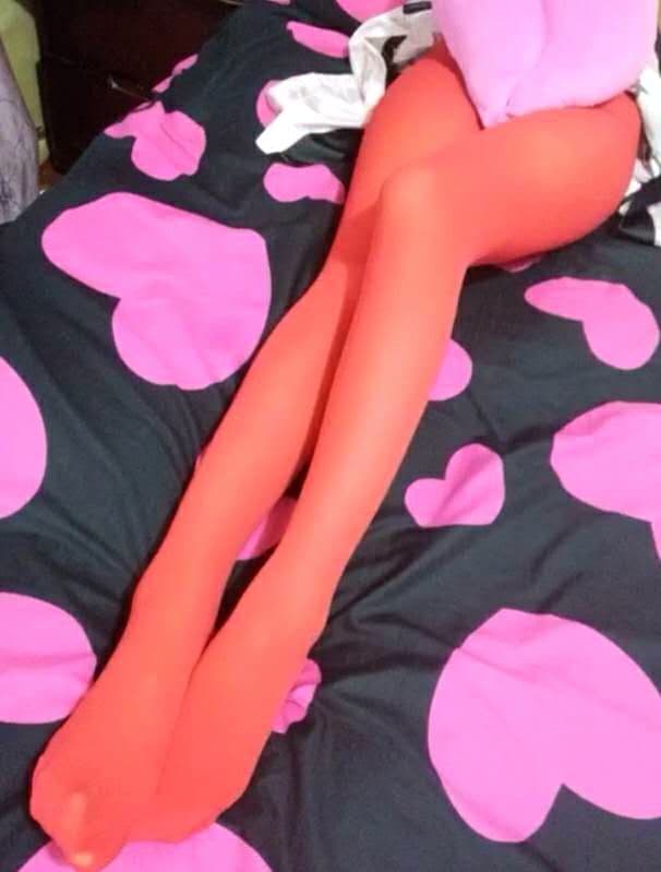 Closeup of feet slipping into soft silk socks, fabric sheen and gentle wrinkles highlighting the arch and toes