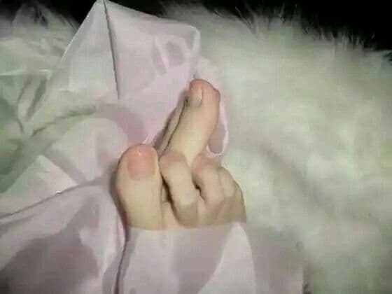 Close portrait of elegant feet posed toward camera, toes painted and arch emphasized under soft studio lighting