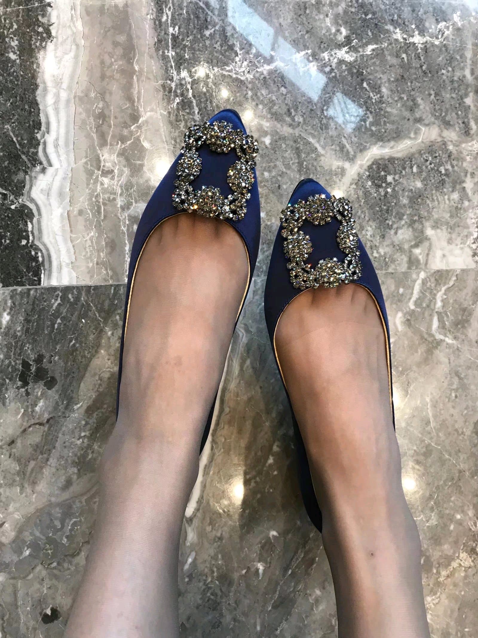 Dynamic shot of a foot mid-swing with sock sliding to reveal a bare arch and tension in fabric