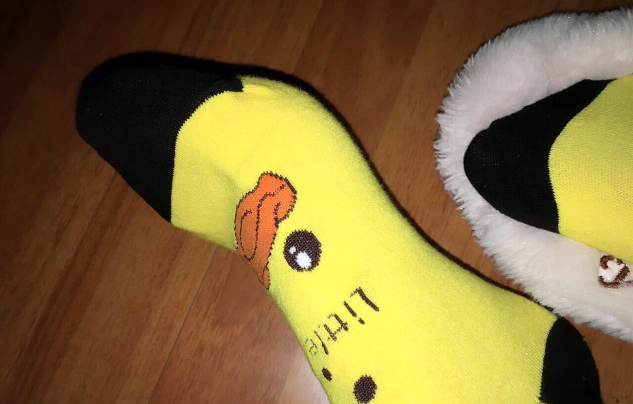 Artful pairing of a casual snack scene with close-up of feet in short silk socks, toes relaxed and textured contrast