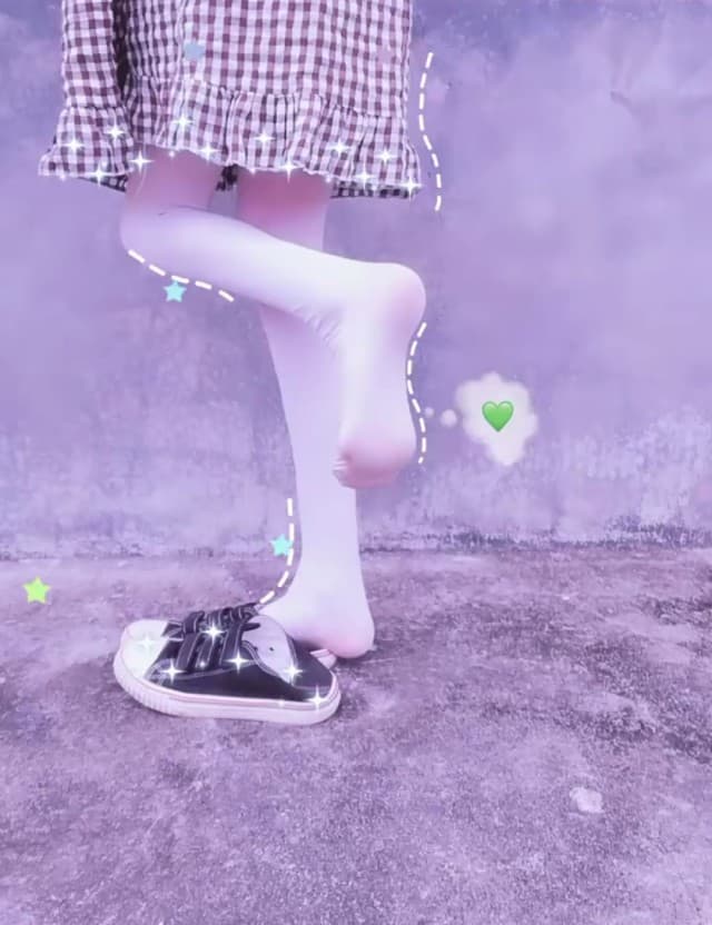 Close-up of bare feet on silk, toes slightly curled and heel catching a warm glow