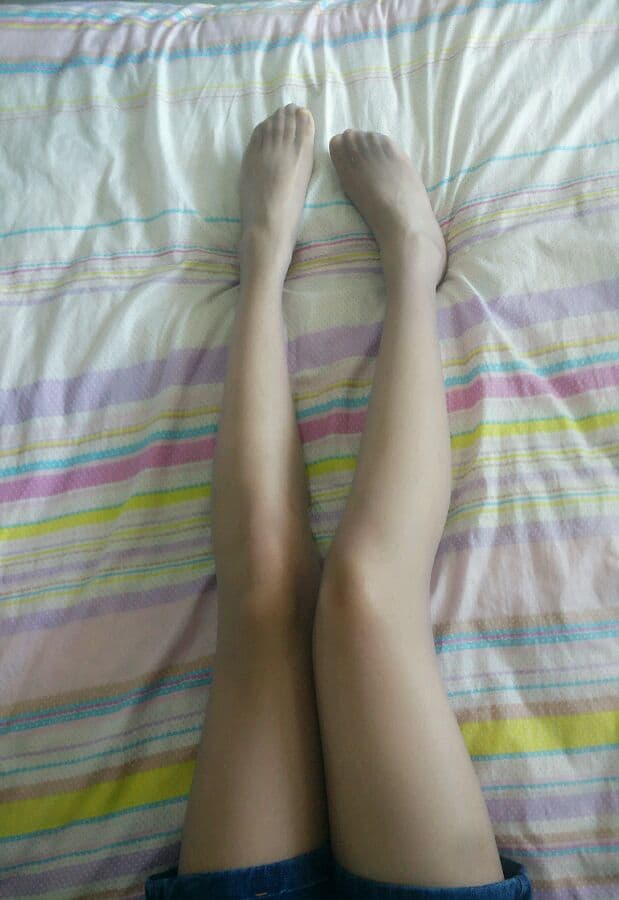 Newcomer toes tucked in soft cotton socks, shy pose, ankles exposed for a coy, tempting glimpse.